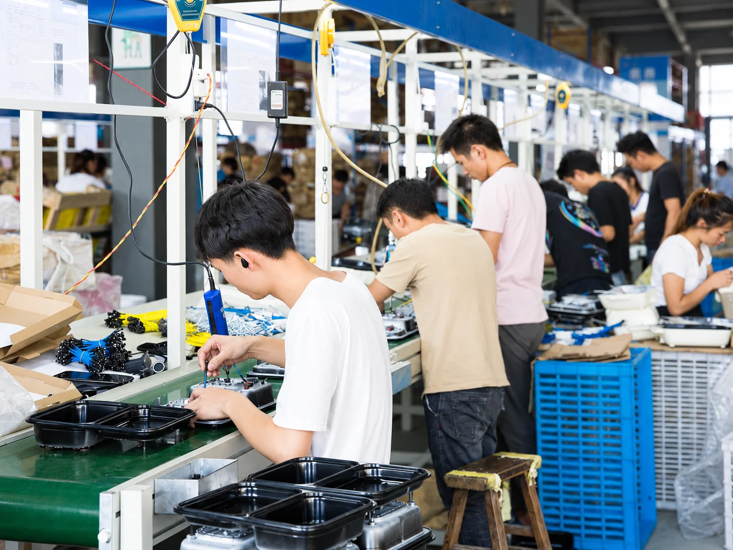 Staff assembling cookware on the production line.