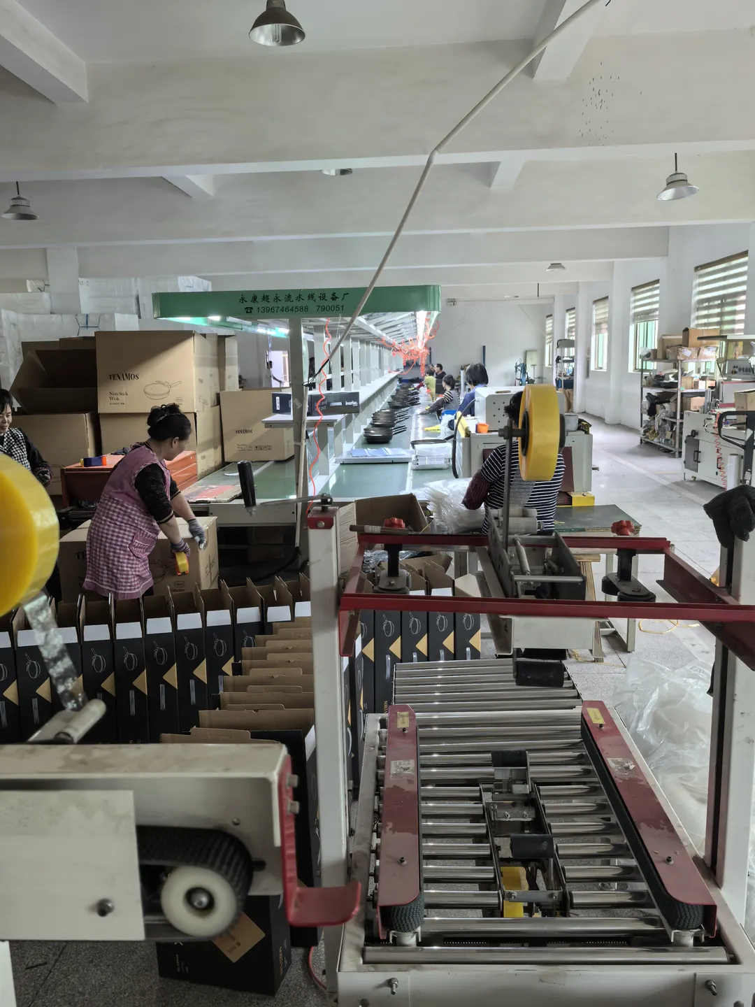 Workers and conveyors inside the assembly workshop