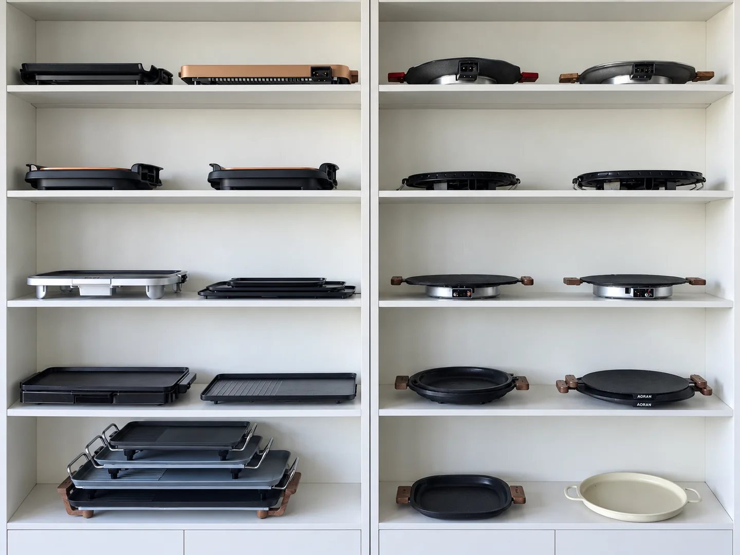 Grill plates and griddle samples displayed on shelves