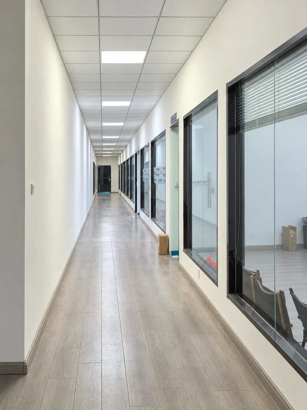Office corridor with glass-fronted rooms