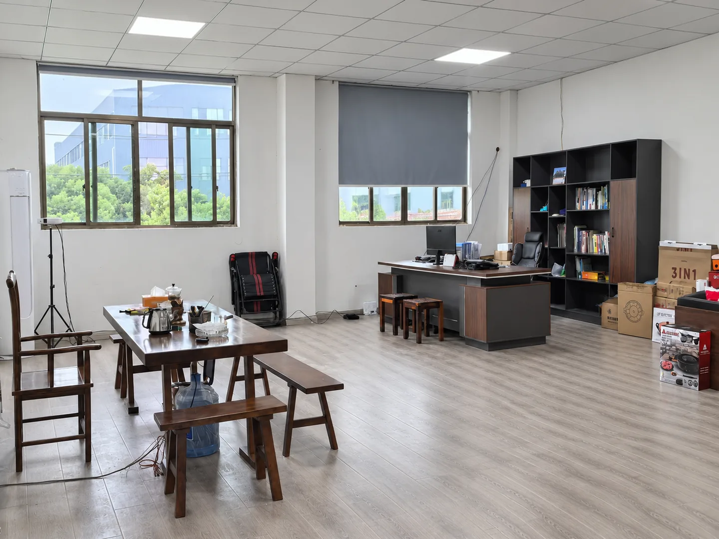 Office desks and seating beside large windows