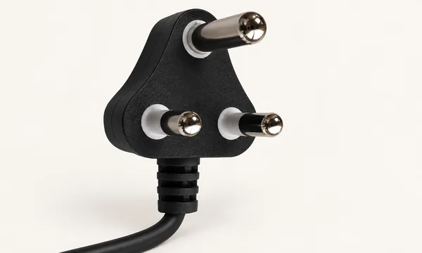 Black South African plug with three round pins and a longer earth pin.