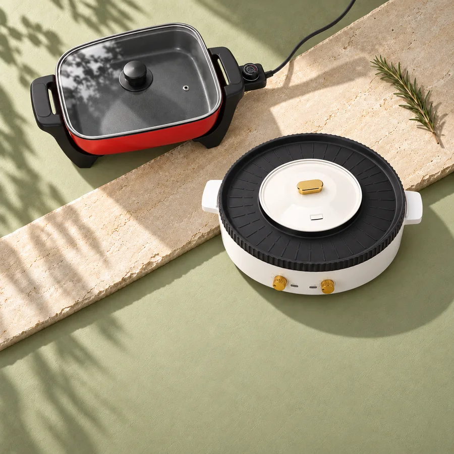 Electric skillet and grill with hot pot on pale sage and ivory stone.